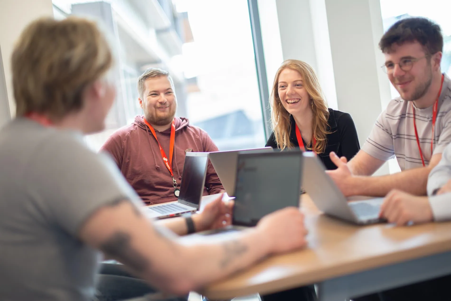 University of Hull graduates chat during a meeting at Summit Media's office