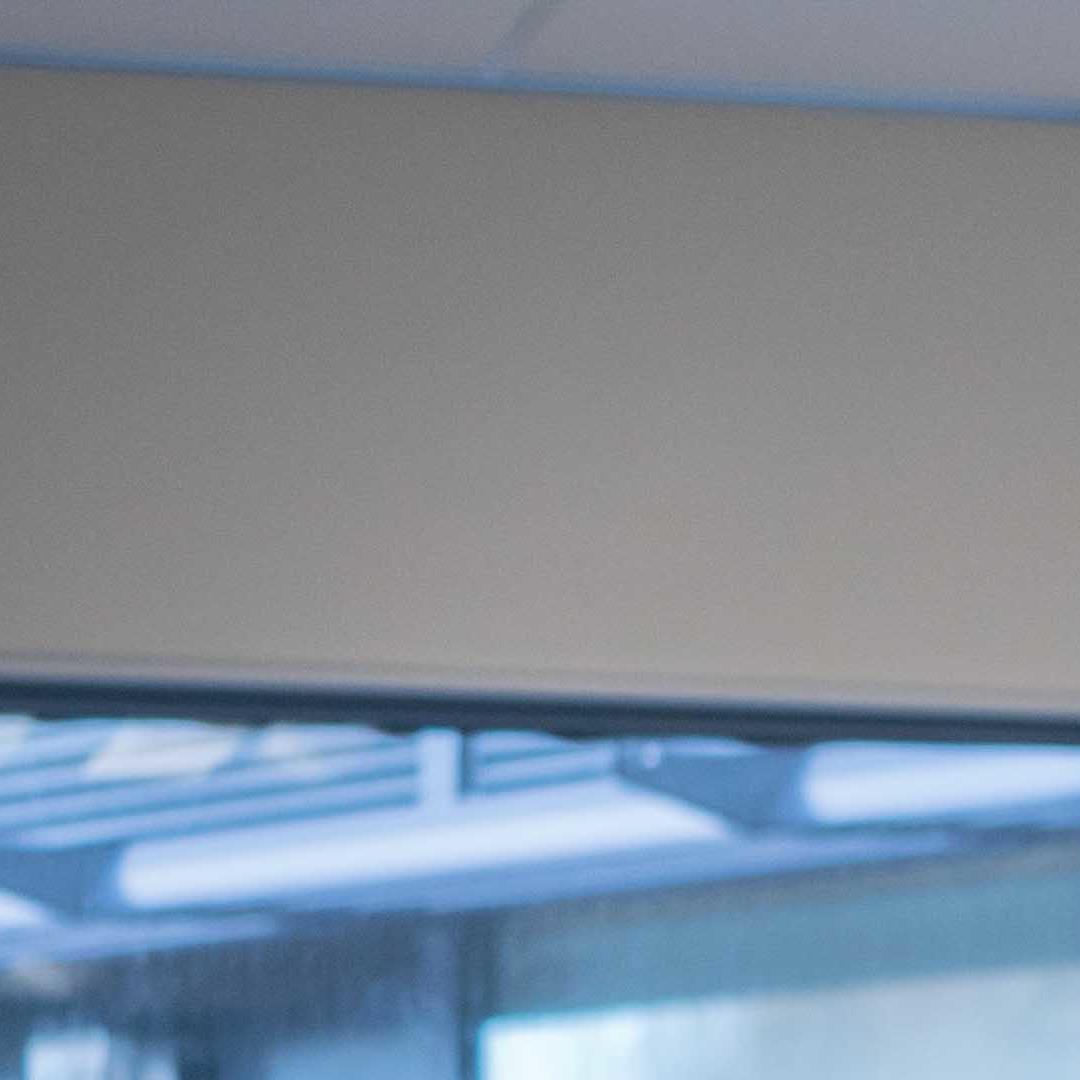 An Education Studies student stood at the front of a class talking to two school pupils during a placement 