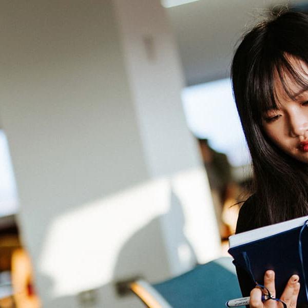 Postgraduate student reading in the Brynmor Jones Library