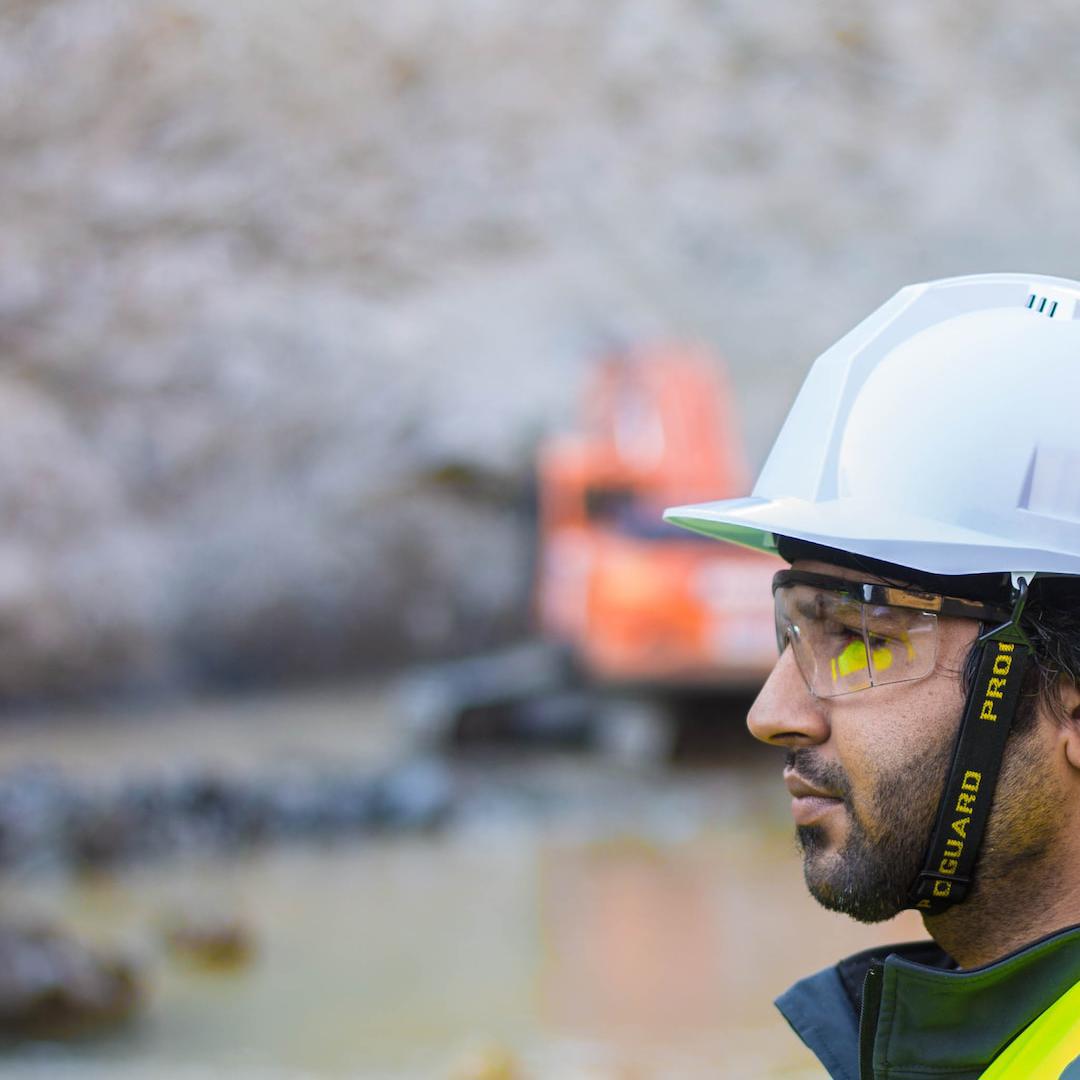 A construction worker in a hi vis jacket and hard hat