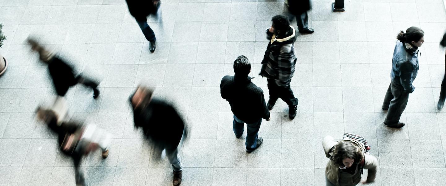 a crowd of people moving through an indoor space